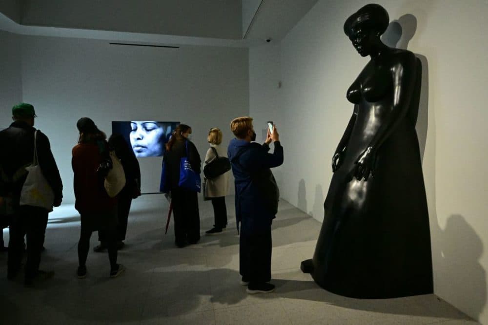 Visitors take in Simone Leigh's works in the U.S. pavilion. The exhibition runs through November. (AFP/Vincenzo Pinto via Getty Images)