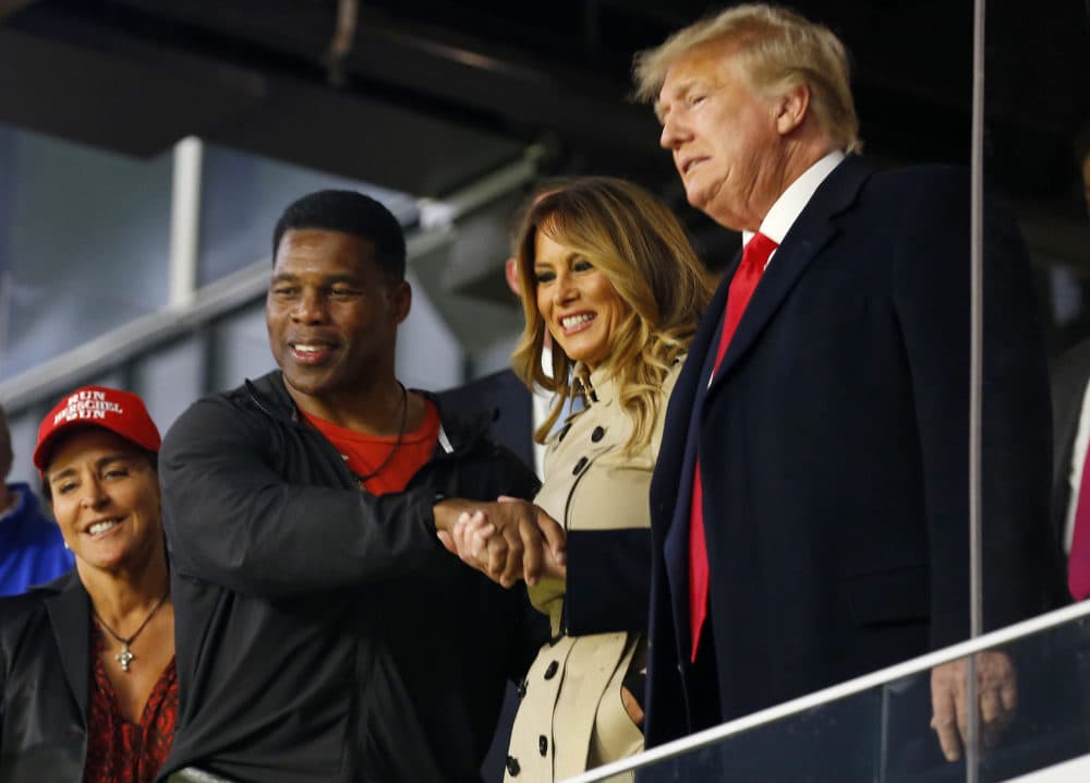 Herschel Walker interacts with former president of the United States Donald Trump prior to Game Four of the World Series between the Houston Astros and the Atlanta Braves Truist Park on October 30, 2021 in Atlanta, Georgia. (Michael Zarrilli/Getty Images)