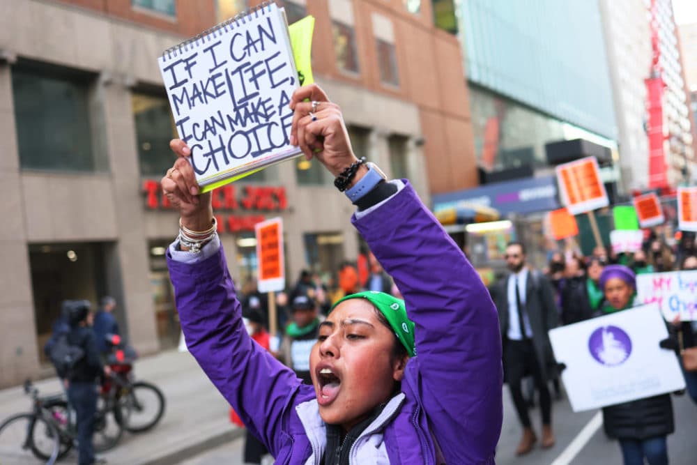 People participate in a march to mark International Women's Day on March 08, 2022 in New York, New York. (Michael M. Santiago/Getty Images)
