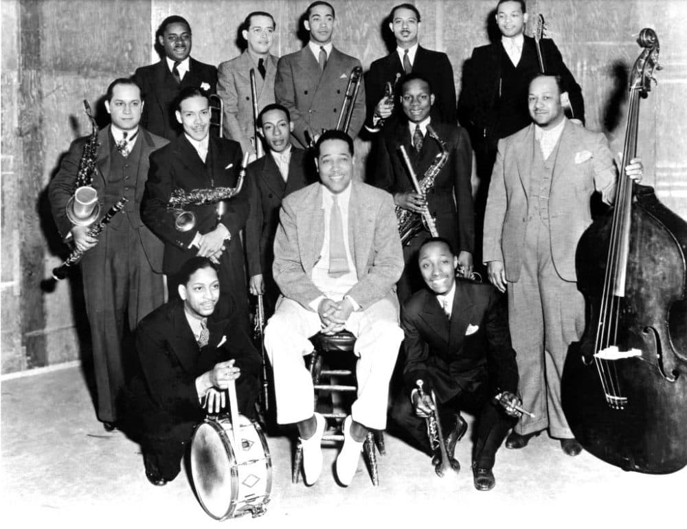 The Duke Ellington Orchestra pose for a group shot in 1934 with Duke Ellington in centre, Sonny Greer kneeling left and Freddy Jenkins right then (left to right) (middle) Barney Bigard, Marshall Royal, Johnny Hodges, Harry Carney and Wellman Braud, (back) Cootie Williams, Juan Tizol, Lawrence Brown, Arthur Whetsol and Fred Guy. (Photo by JP Jazz Archive/Redferns via Getty)