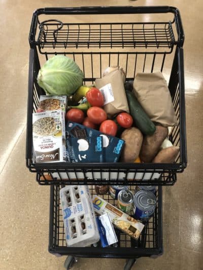 A shopping cart filled with plastic-free foods. (Martha Bebinger/WBUR)