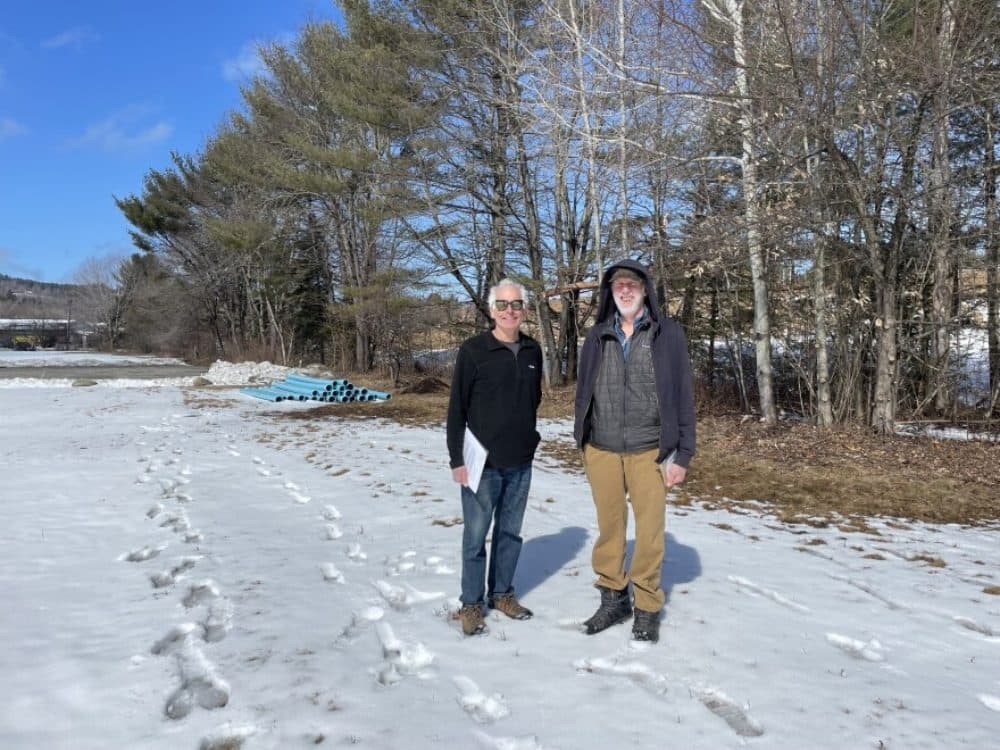 Chris Dubé and Jim Fitzpatrick stand on the site where a new solar array will be installed, after Franconia voters approved funds for the array at their town meeting in March. (Mara Hoplamazian/NHPR)