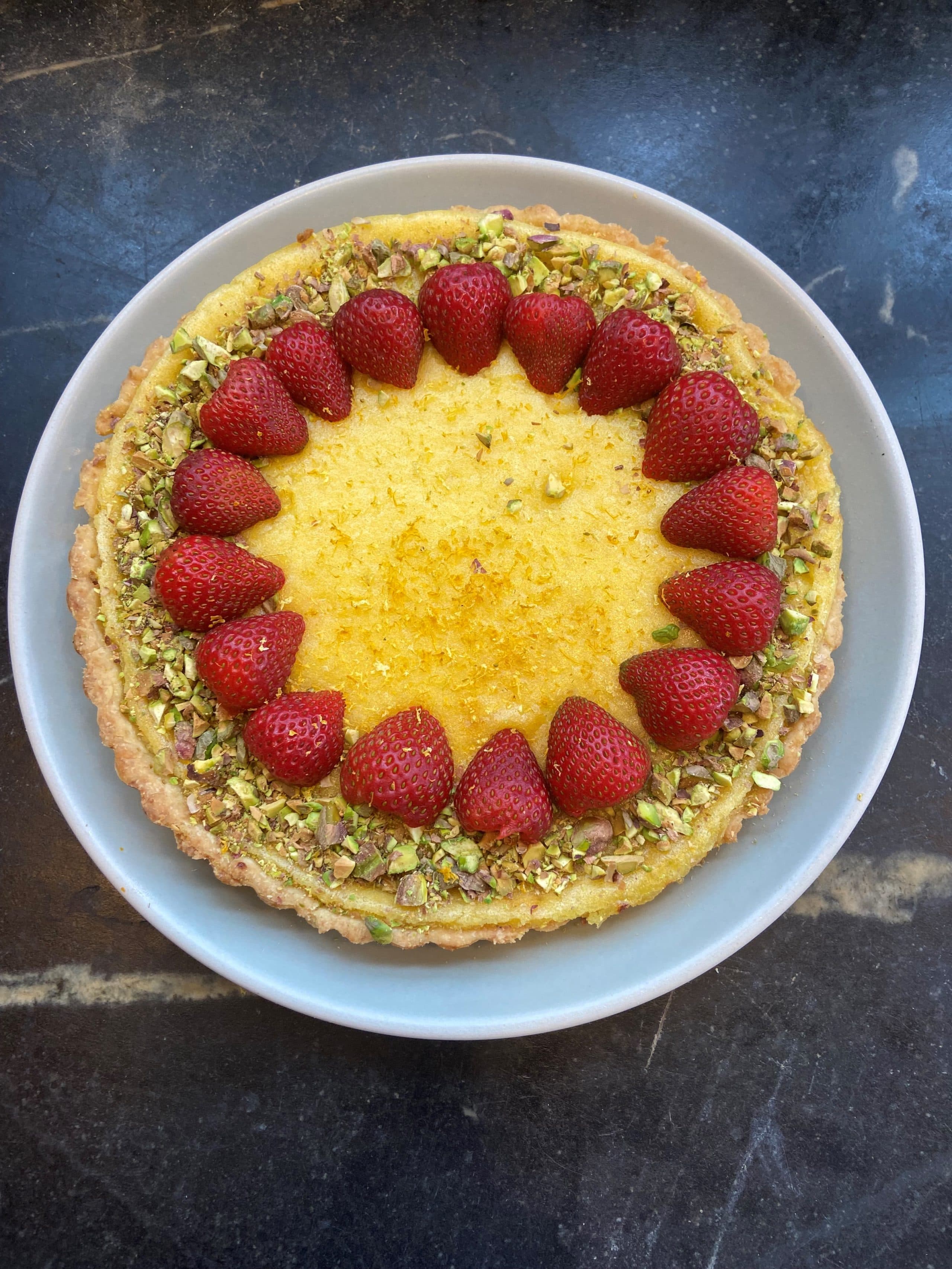 Meyer lemon curd tart with strawberries and pistachio dust. (Kathy Gunst)