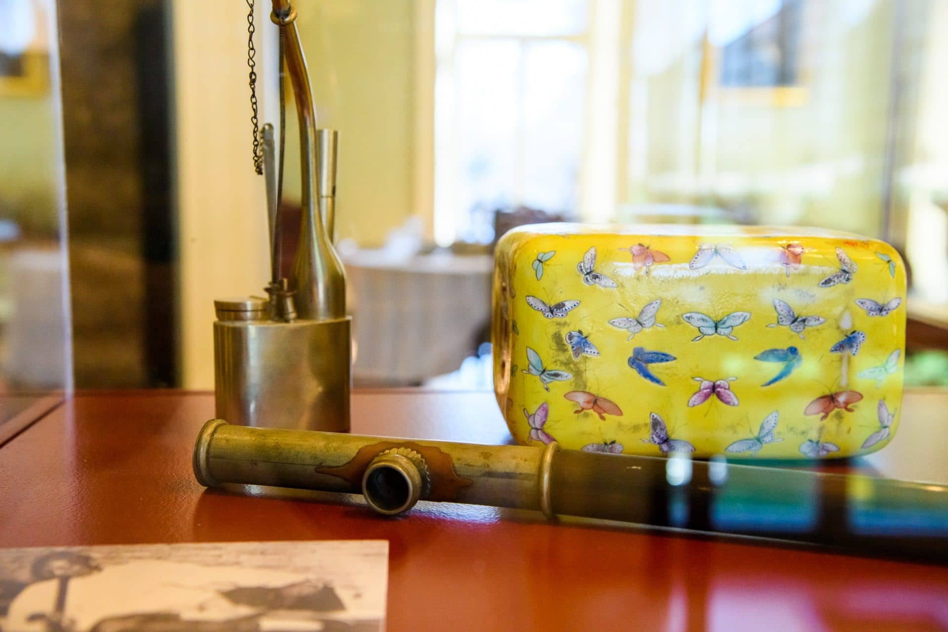 Opium pipes with a porcelain opium pillow. The pillows were cool and hollow, and often had an opening on one end where valuables could be stored while smoking. (Courtesy Ellen Rogers Photography)