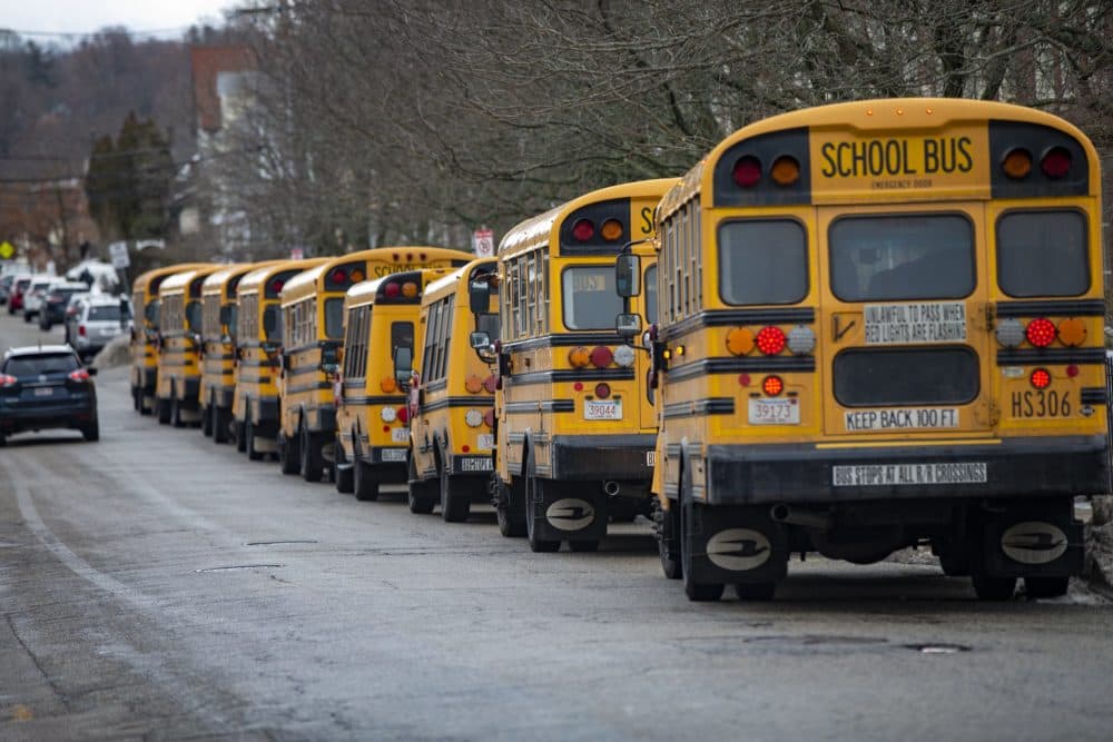 School busses lined up outside of New Mission High School in Hyde Park awaiting students prior to school release. (Jesse Costa/WBUR)
