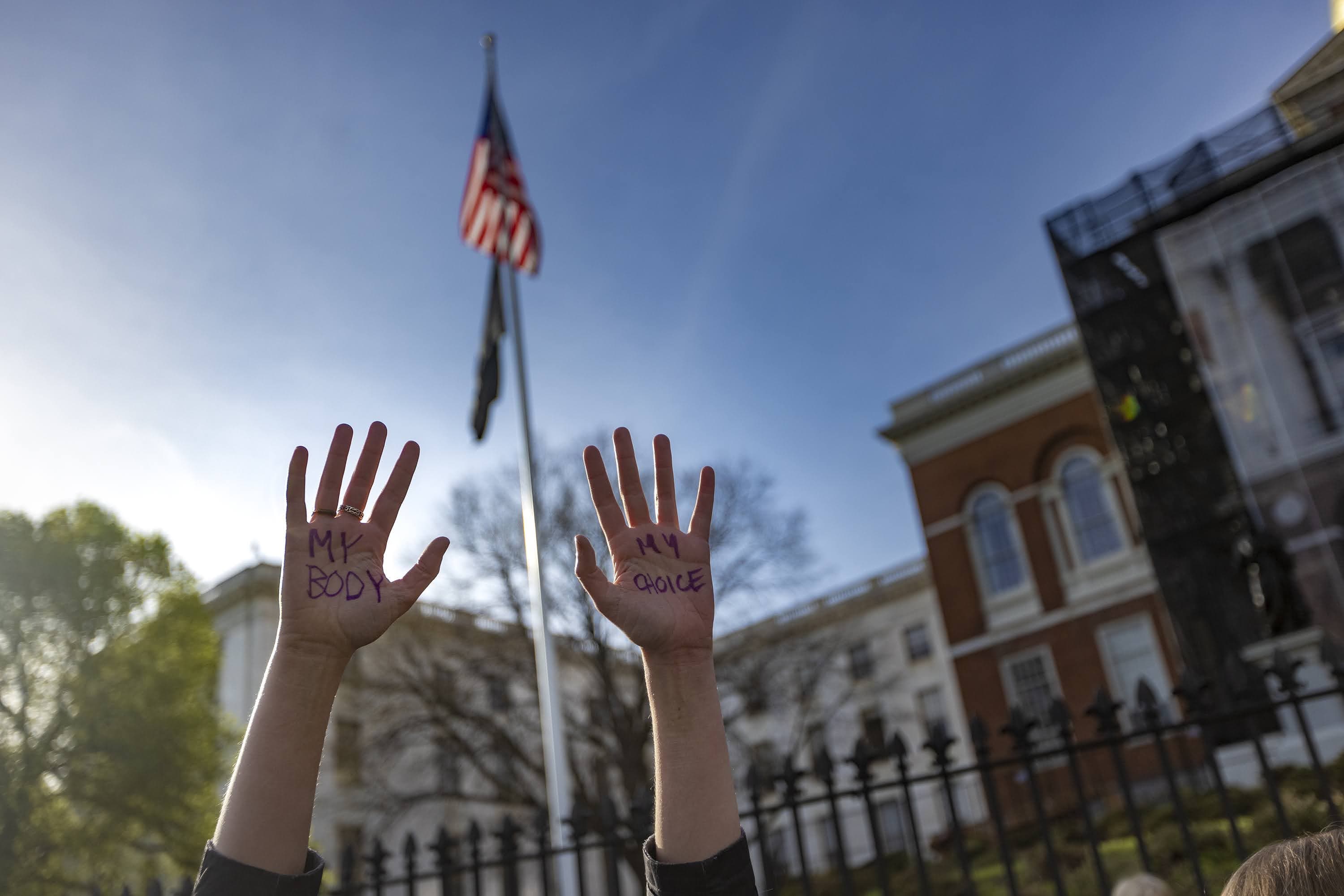 Alexa Steele wrote the words "my body my choice" on the palms of her hands as she joined thousands of others at the Defend Abortion Rights rally at the Massachusetts State House. (Jesse Costa/WBUR)