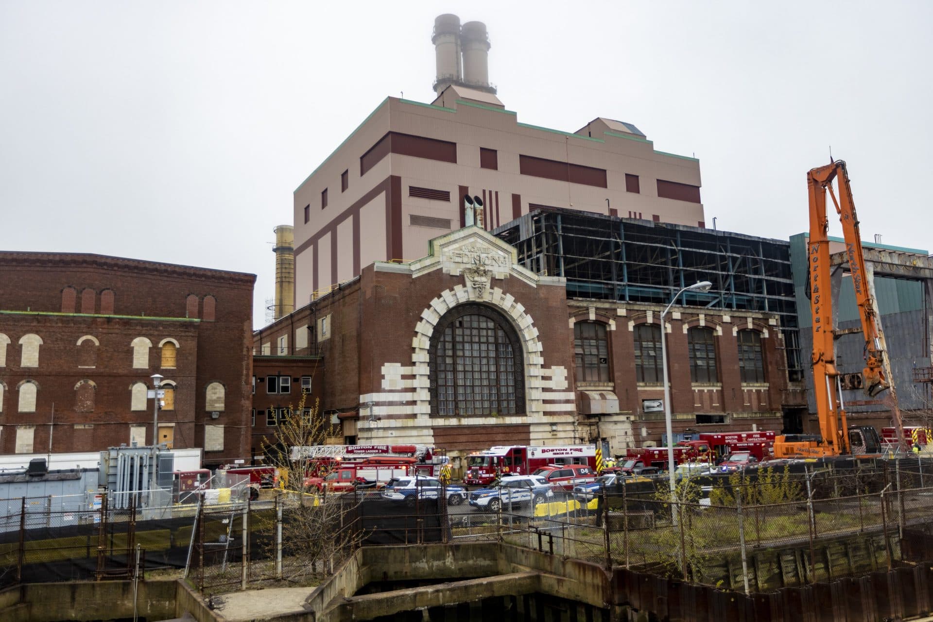 Emergency crews parked outside of the old Edison Building in South Boston, where three workers were injured during the collapse of a catwalk. (Jesse Costa/WBUR)