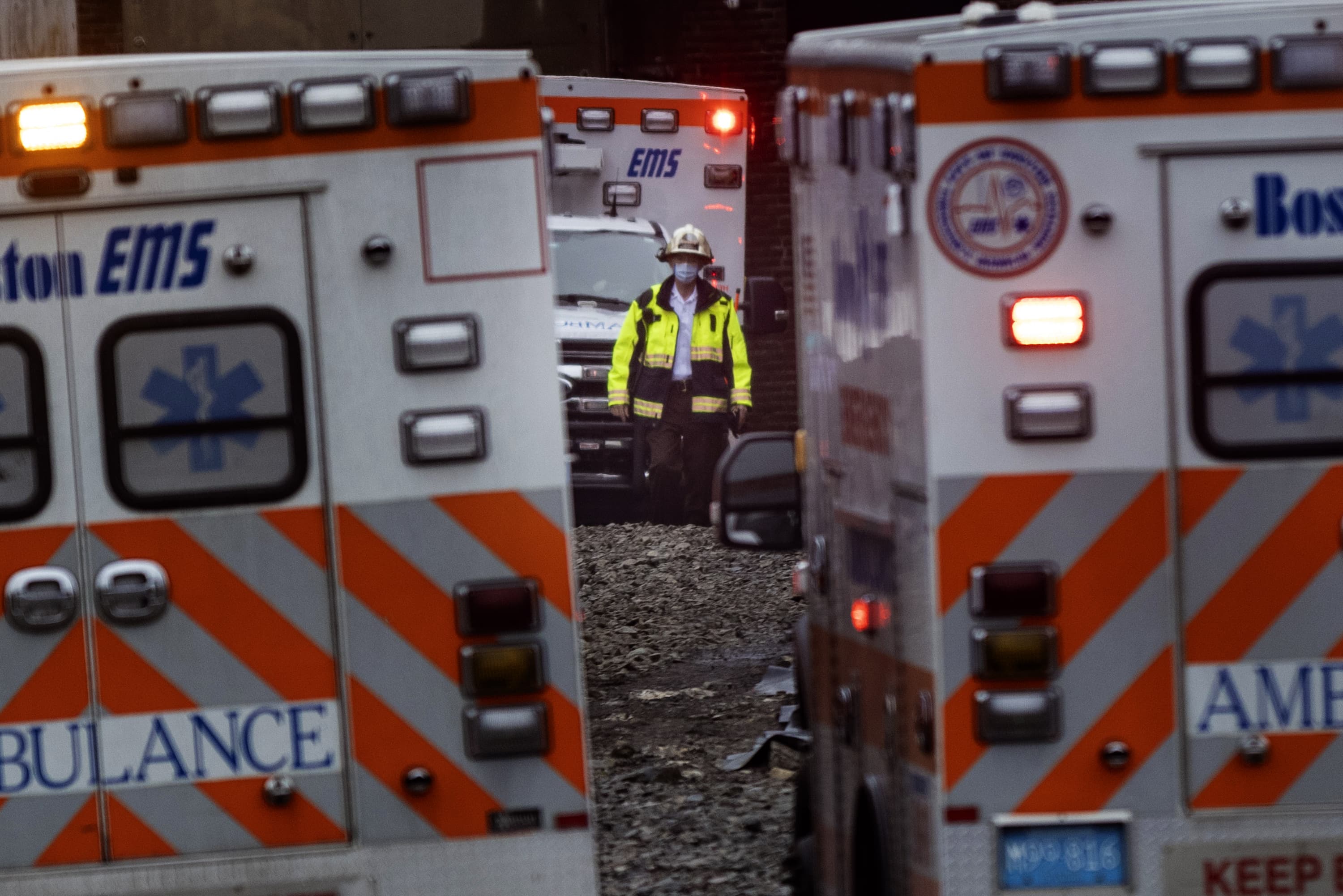 A firefighter walks out from the old Edison Building in South Boston where three workers were injured during the collapse of a catwalk. (Jesse Costa/WBUR)