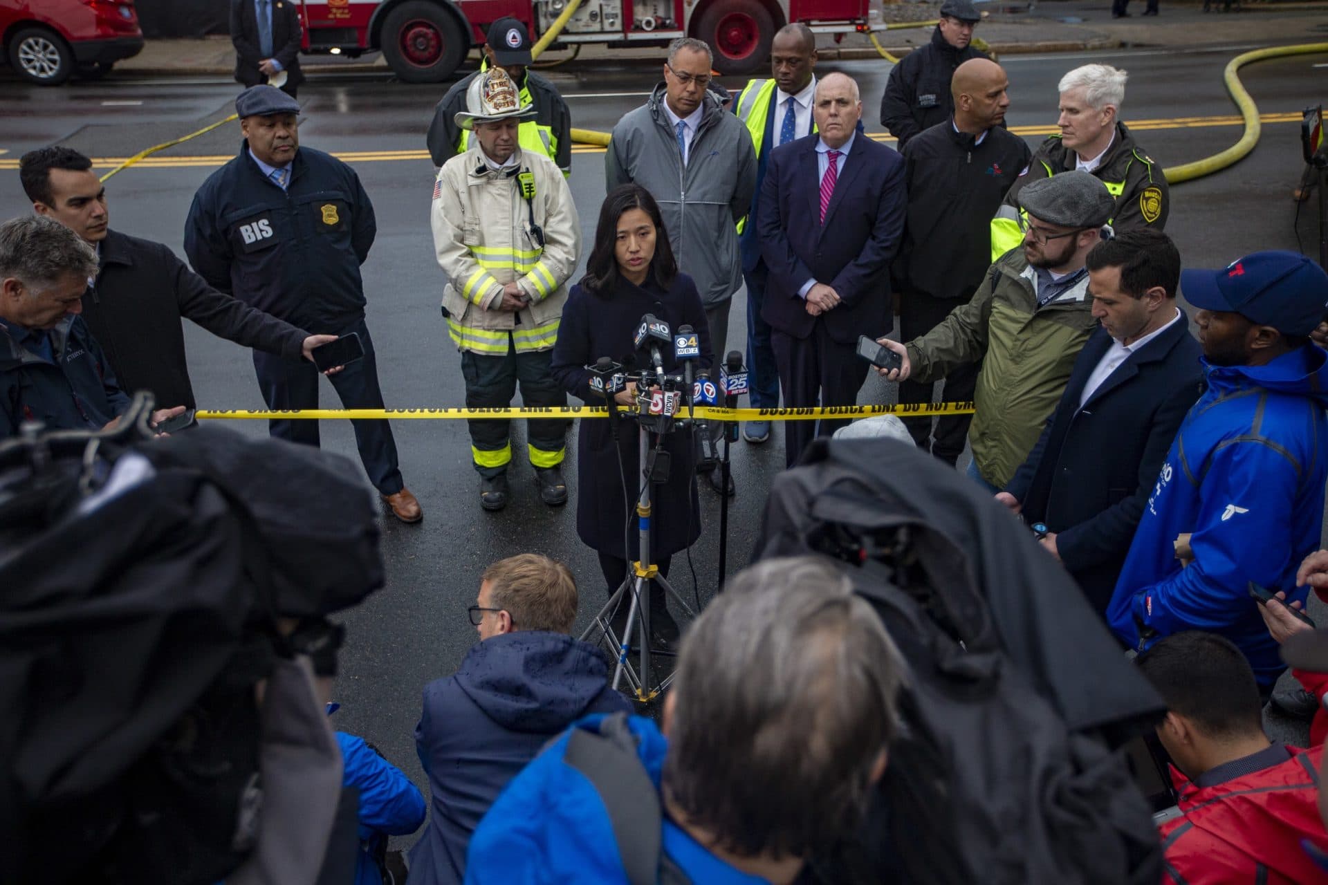 Mayor Michelle Wu speaks with the press after touring the scene of the accident at the old Edison Building in South Boston. (Jesse Costa/WBUR)