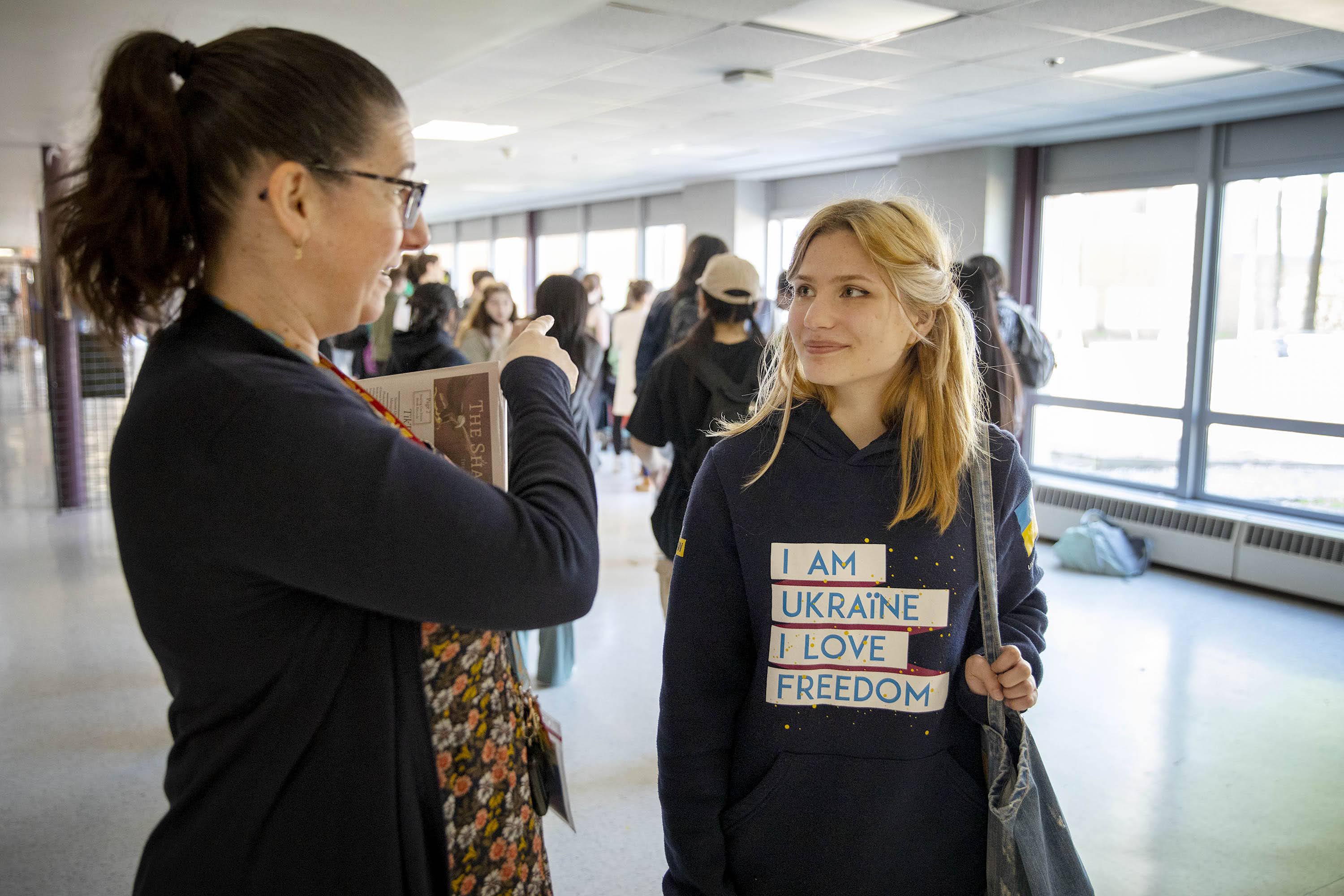 Svitlana Pokliatska talks with Assistant Superintendent Meg Dussault during a class break at Sharon High School. (Robin Lubbock/WBUR)