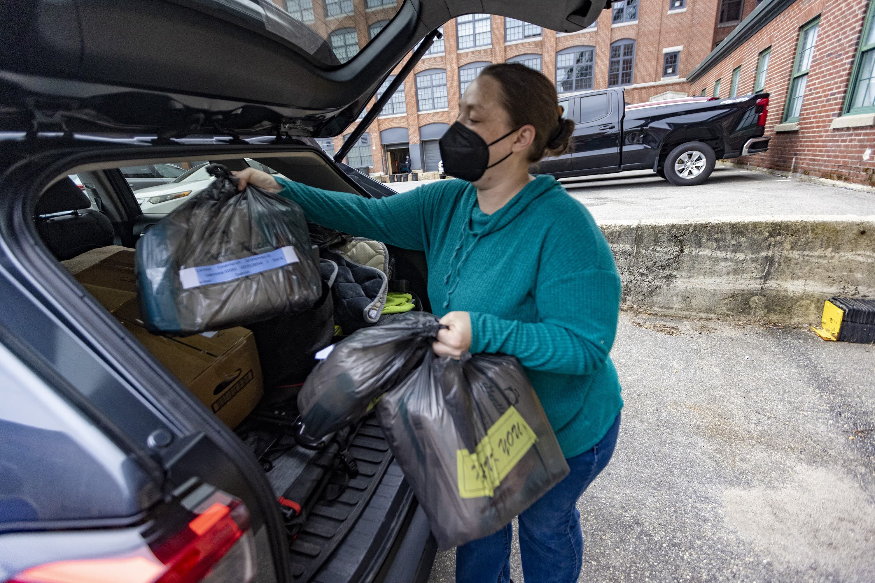 Maggie Clougherty loads up her SUV with diaper orders to make deliveries around the Lawrence area for Neighbors In Need. (Jesse Costa/WBUR)