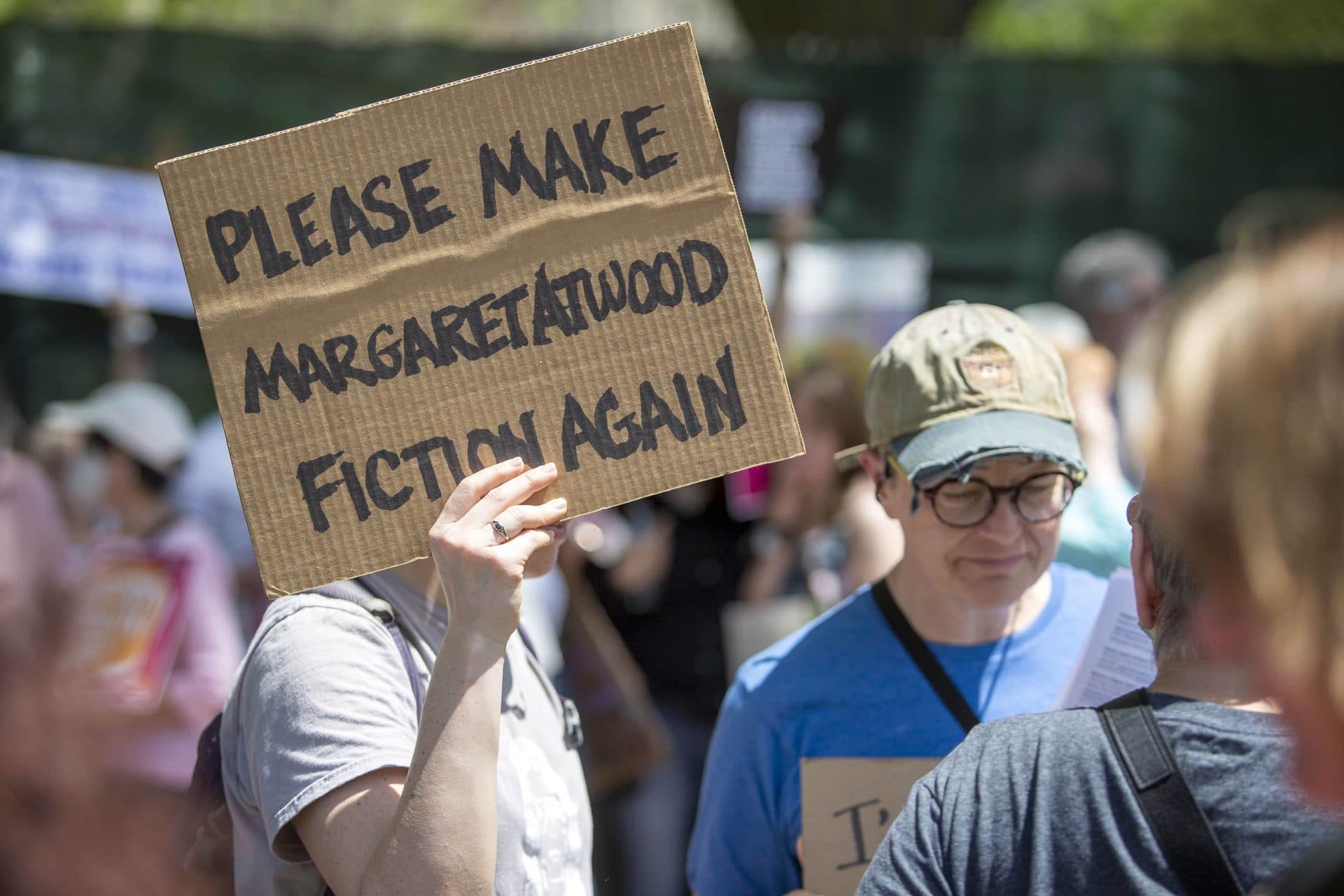 A protester holds up a sign saying 