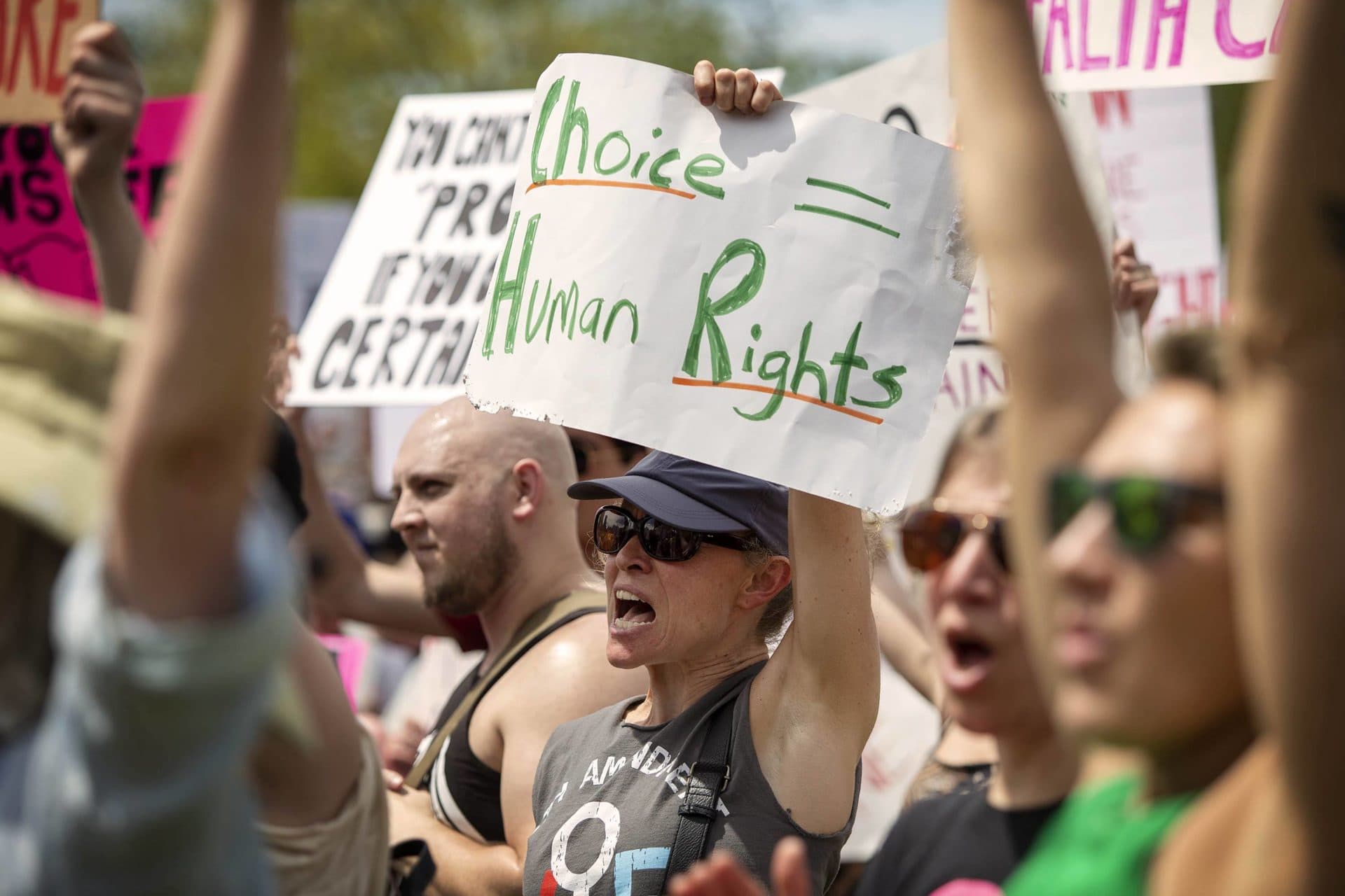 A protester holds up a sign saying 