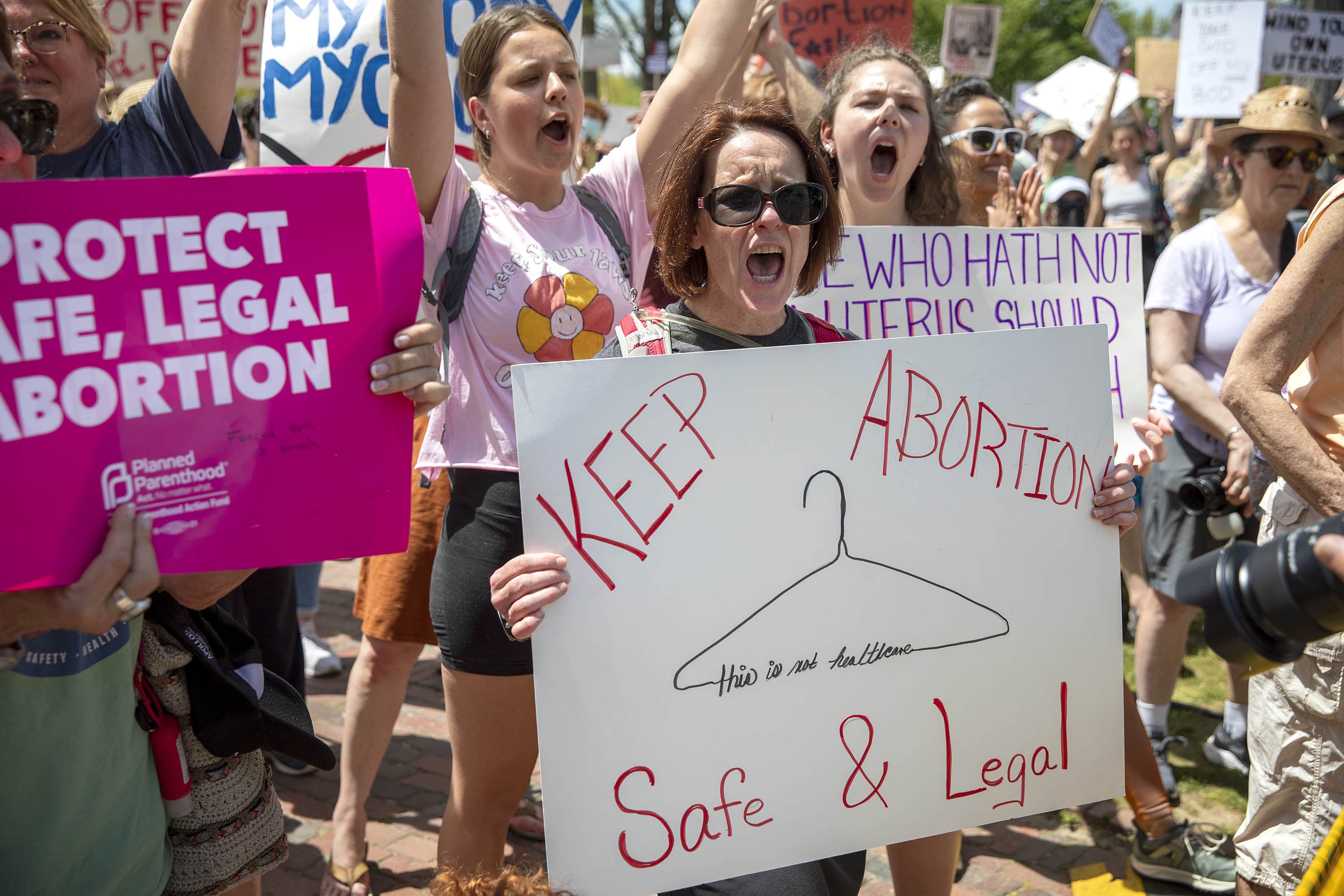 A protester holds up a "Keep Abortion Safe &amp; Legal" sign at the Bans Off Our Bodies rally on Boston Common. (Robin Lubbock/WBUR)