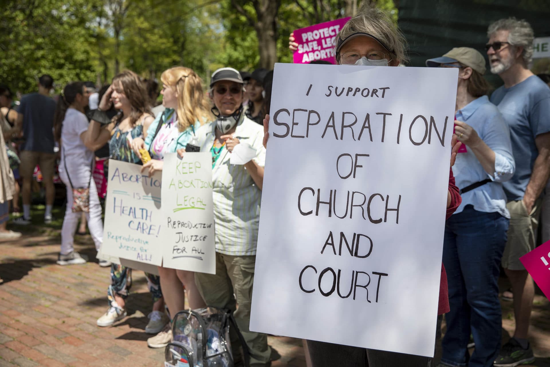 Protester Willa Michener holds up a sign saying &quot;I Support Separation Of Church And Court&quot; at the Bans Off Our Bodies rally on Boston Common. (Robin Lubbock/WBUR)