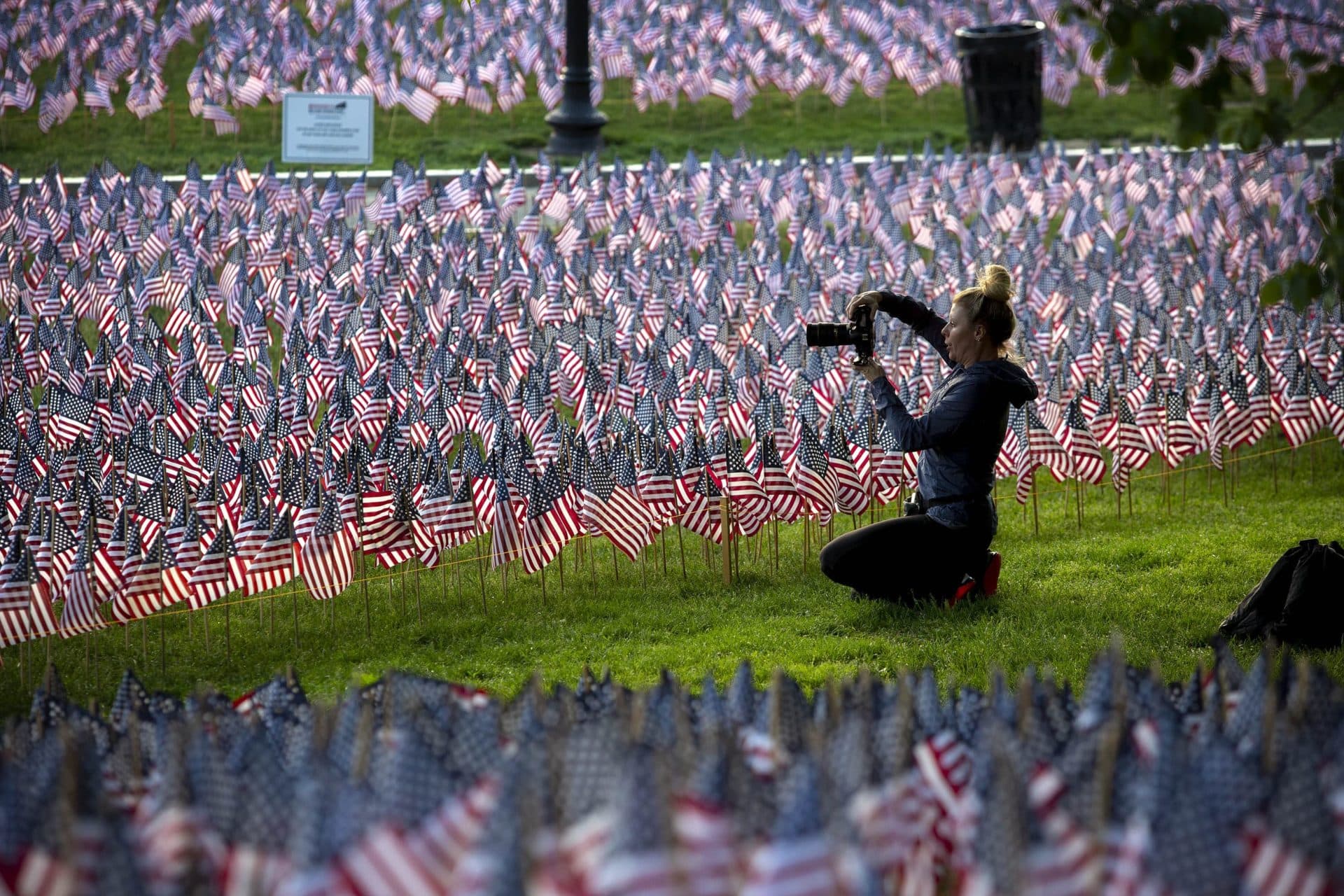 A photographer captures an image of the thousands of flags planted in memory of fallen Massachusetts service members for Memorial Day. (Robin Lubbock/WBUR)