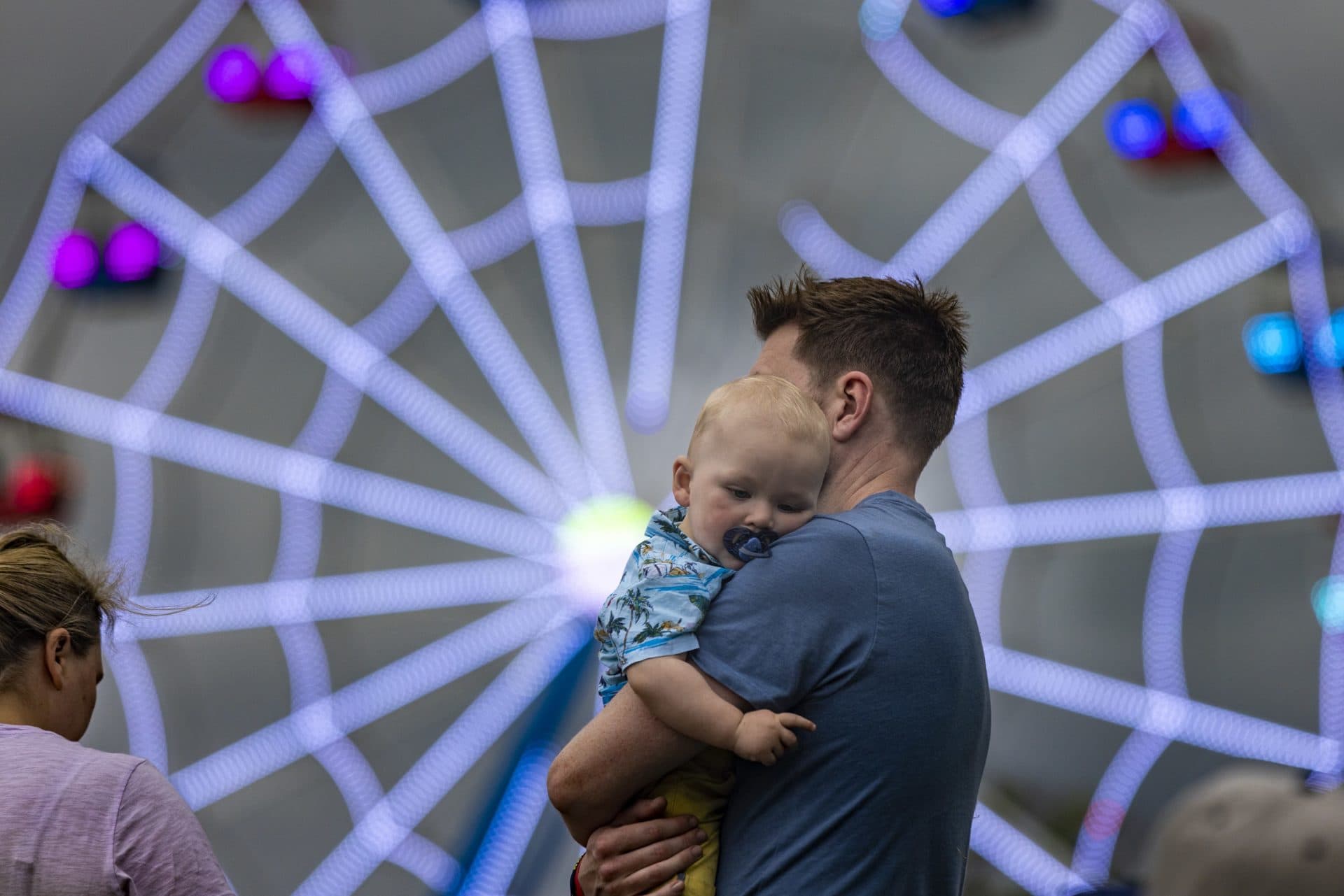 A baby rests on the shoulder of his dad before the Avril Lavigne show at the Boston Calling Music Festival. (Jesse Costa/WBUR)