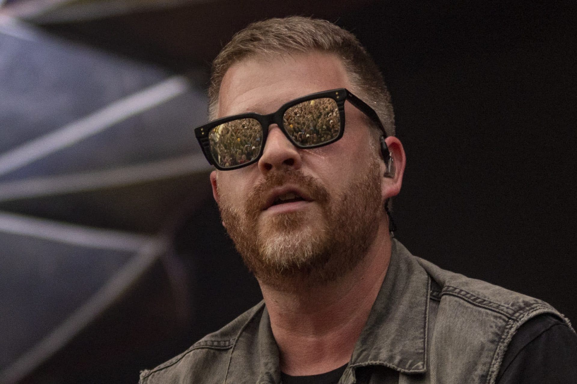 The crowd is reflected in the mirrored sunglasses of El-P during Run the Jewels' set. (Jesse Costa/WBUR)