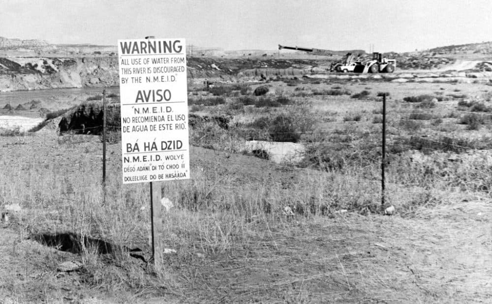 Signs along the Rio Puerco warning residents in three languages to avoid the water in Church Rock, N.M. after a uranium tailings spill. (AP Photo/SMH,File)