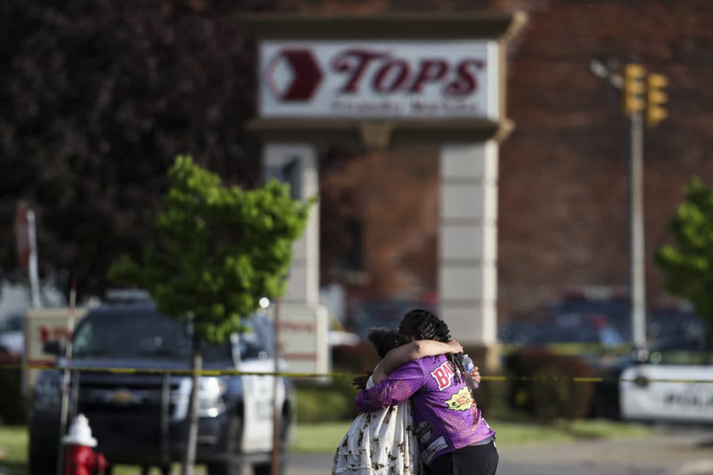 People hug outside the scene after a shooting at a supermarket on Saturday, May 14, 2022, in Buffalo, N.Y. (Joshua Bessex/AP)