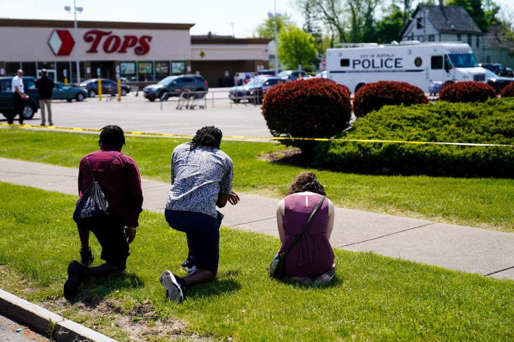 People pray outside the scene of Saturday's shooting at a supermarket, in Buffalo, N.Y., Sunday, May 15, 2022. (Matt Rourke/AP)