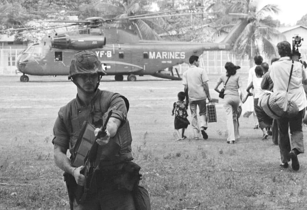 In this April 12, 1975 file photo, U.S. Marines provide cover during Operation Eagle Pull as Americans and Cambodians board Marine helicopters in Phnom Penh during the final U.S. pullout of Cambodia. (AP Photo/File)