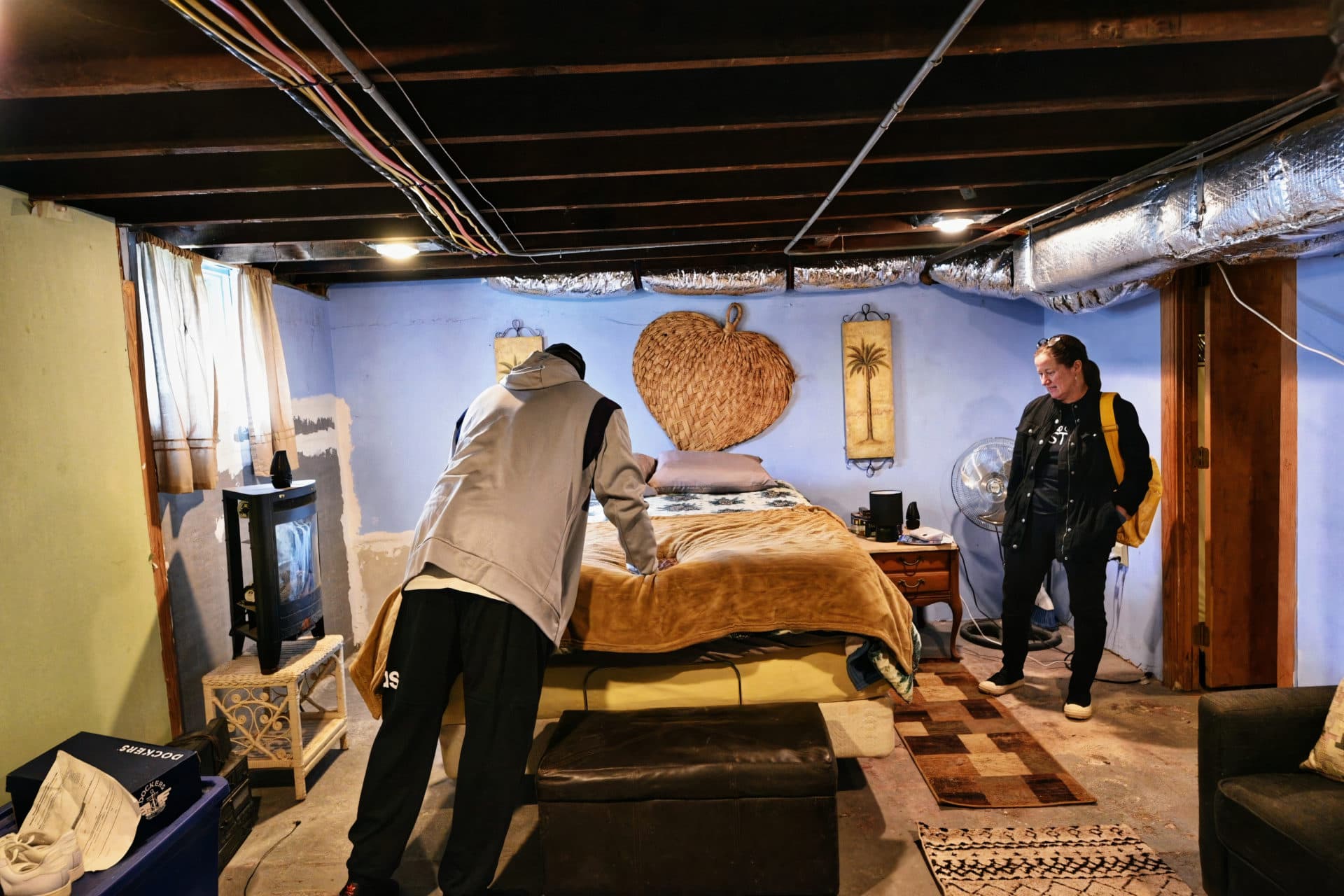 William Allen speaks with Karen Elliott Greisdorf of Massachusetts Communities Action Network as he settles into his bedroom hours after being released from prison. (Photo courtesy Patty DeJuneas)