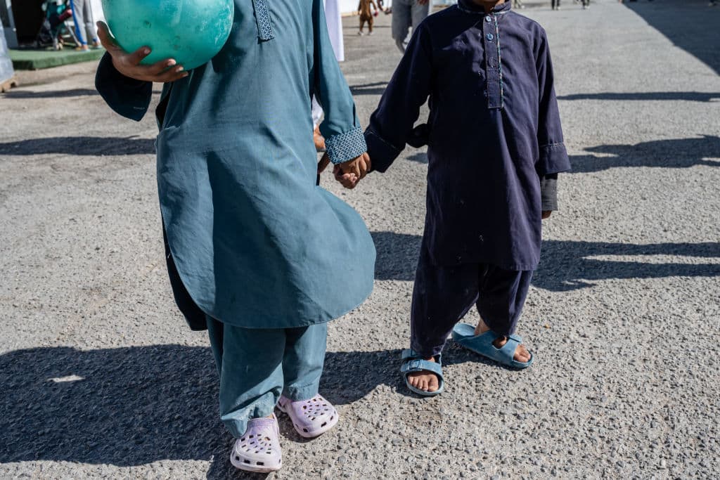 Afghan refugee children stand for a photograph in an Afghan refugee camp on November 4, 2021 in Holloman Air Force Base, New Mexico. (Jon Cherry/Getty Images)