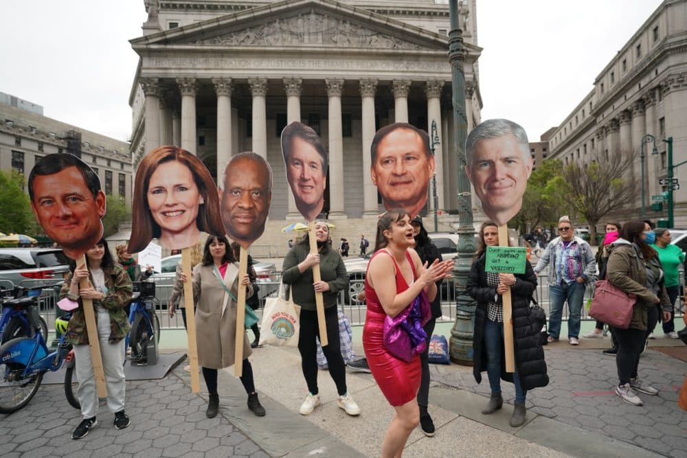 People hold up cardboard cutout of Supreme Court justices as they protest in reaction to the leak of the US Supreme Court draft abortion ruling on May 3, 2022 in New York. (Bryan R. Smith/AFP via Getty Images)