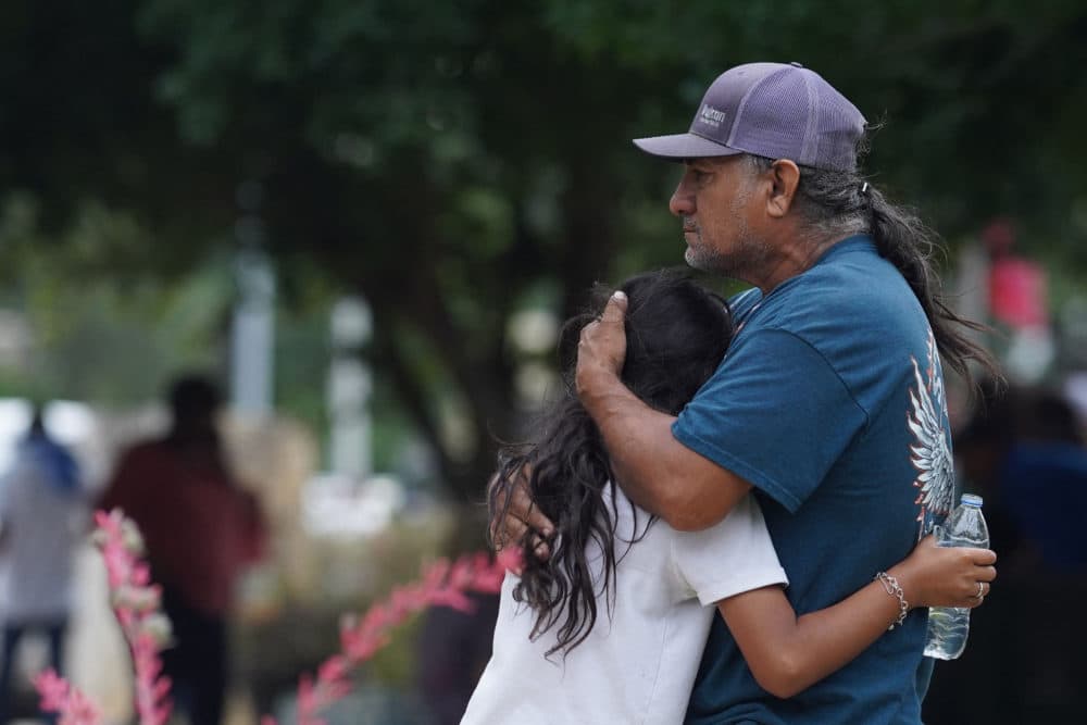 Families hug outside the Willie de Leon Civic Center where grief counseling will be offered in Uvalde, Texas, on May 24, 2022. (Allison Dinner/AFP via Getty Images)