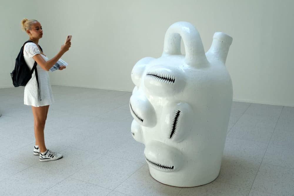 A visitor to the Venice Biennale photographs Simone Leigh's sculpture entitled &quot;Jug.&quot; Leigh has been awarded a Golden Lion at the 59th International Art Exhibition. (Giuseppe Cottini/Getty Images)