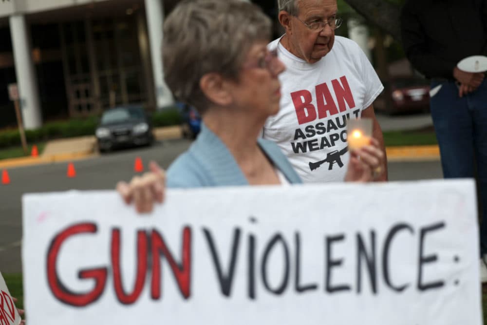 Gun-safety advocates hold a vigil outside of the National Rifle Association (NRA) headquarters following the recent mass shooting at Robb Elementary School on May 25, 2022 in Fairfax, Virginia. (Kevin Dietsch/Getty Images)