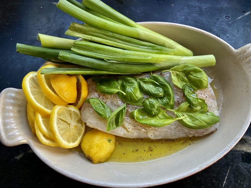 Grilled cod with basil on a lemon and scallion 'bed' (Kathy Gunst/Here & Now)
