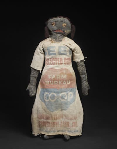 A doll in a feedsack dress, 1900 to 1925. (Ellen McDermott Photography)