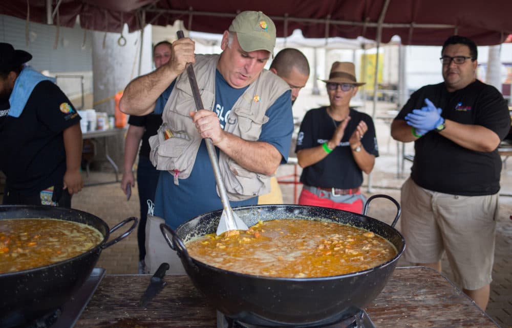 José Andrés (front left) stirs a pot of food in San Juan, Puerto Rico. (National Geographic)