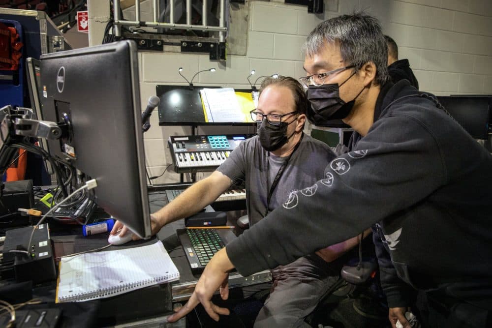 In the musicians area backstage, band leader Conrad Askland and sound technician Splash make preparations for a performance of &quot;Crystal&quot; at the Agganis Arena. (Robin Lubbock/WBUR)