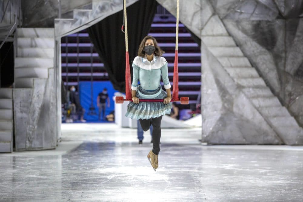 as Cirque du Soleil "crystal"  At Agnis Arena, Hojardis Lee, who plays Crystal in the production, swings on a trapeze over the ice.  (Robin Lubbock/WBUR)