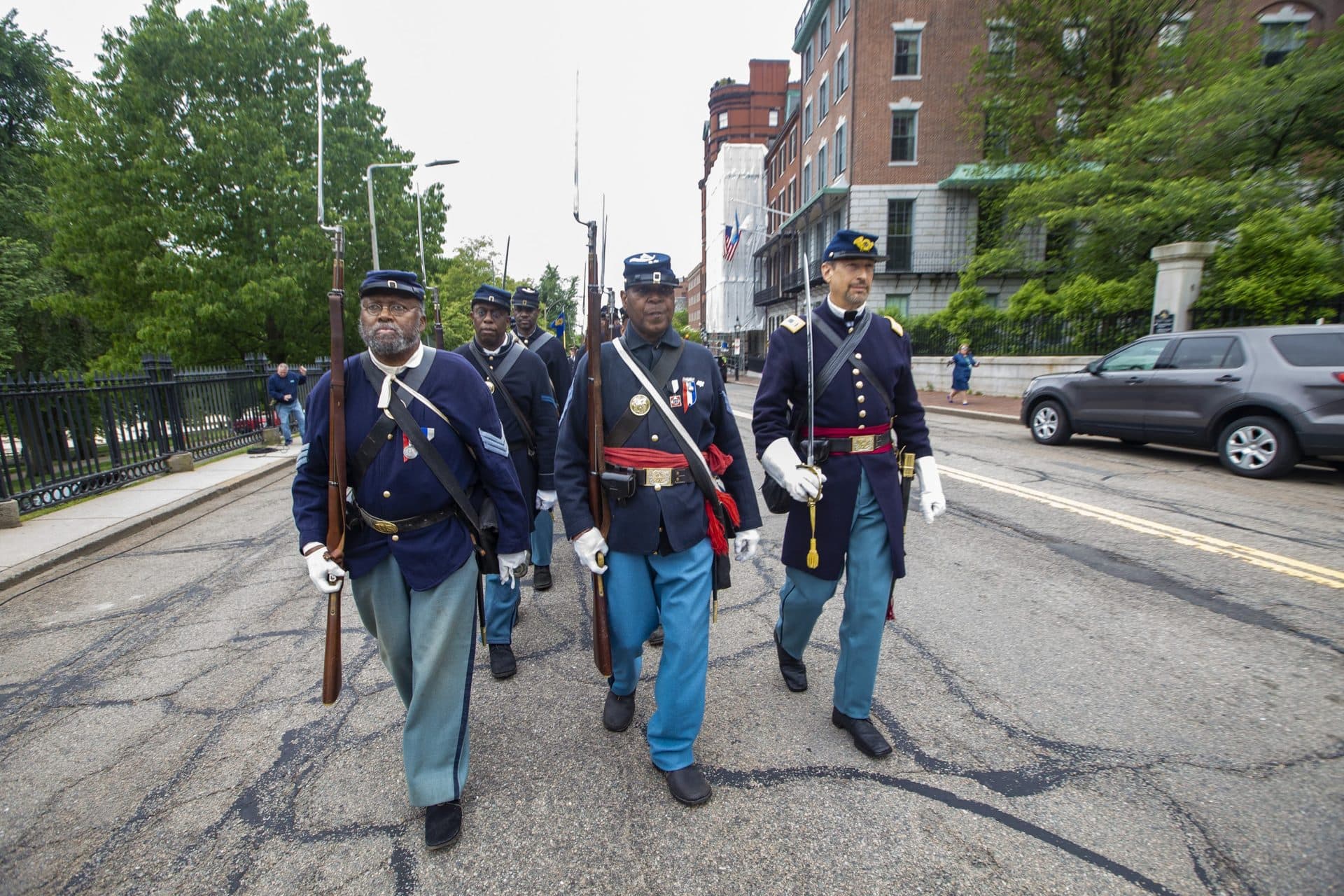 The procession of the 54th Massachusetts Volunteer Regiment marching up Beacon Street towards the Robert Gould Shaw and the 54th Regiment Memorial. (Jesse Costa/WBUR)