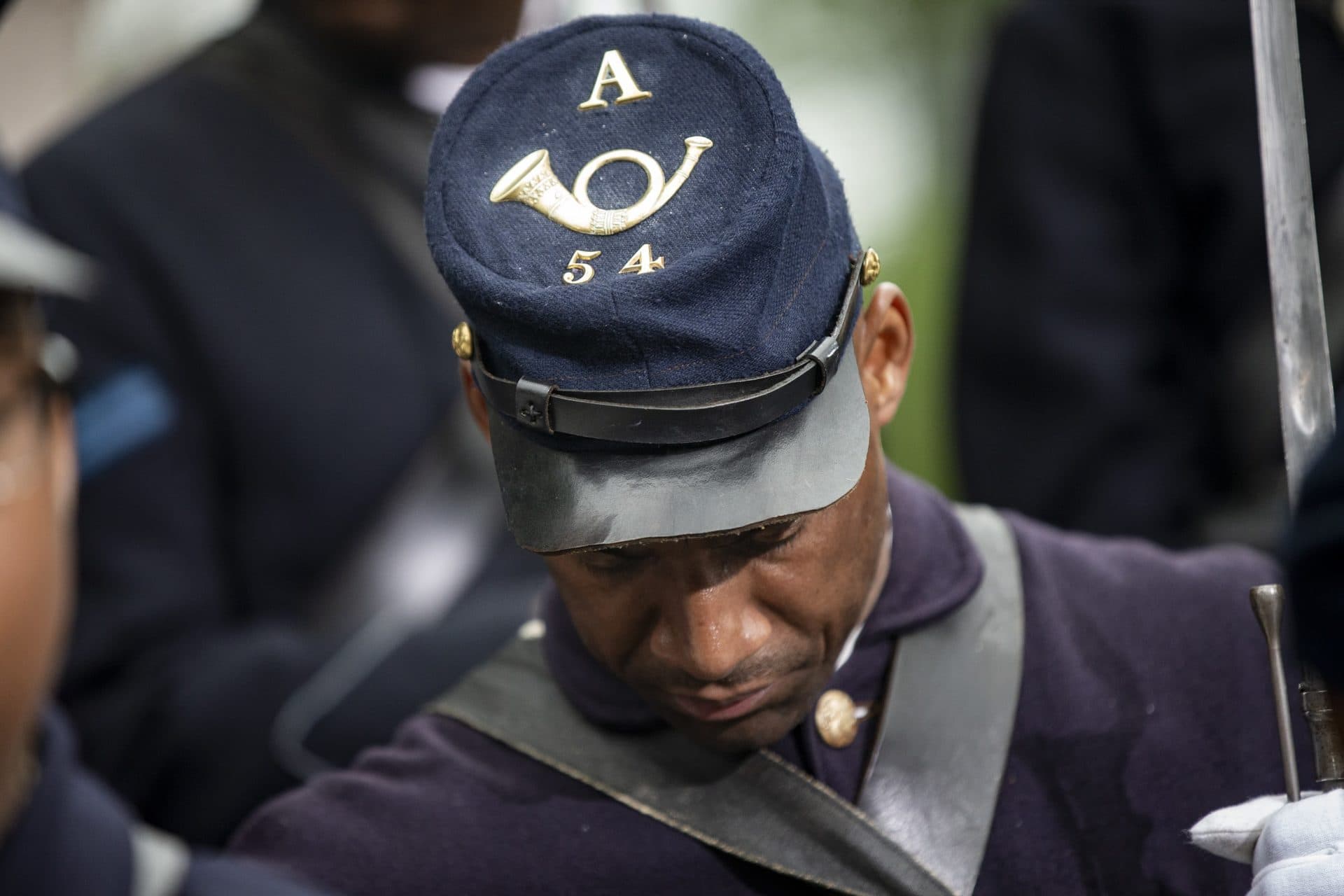 A member of the 54th Massachusetts Volunteer Regiment holds his head down during the Robert Gould Shaw and the 54th Regiment Memorial rededication ceremony. (Jesse Costa/WBUR)