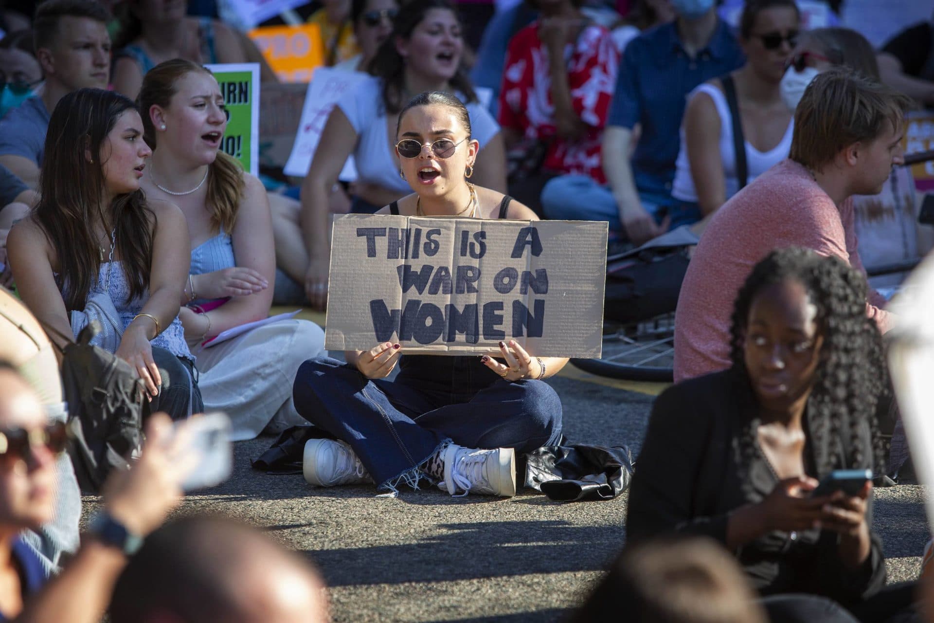 Abortion-rights protesters sit-in on Park Plaza during their march through Boston. (Robin Lubbock/WBUR)