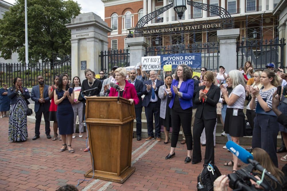 Sen. Elizabeth Warren speaks to a crowd gathered outside the Massachusetts State House to protest the Supreme Court's decision to overturn Roe v. Wade. (Robin Lubbock/WBUR)