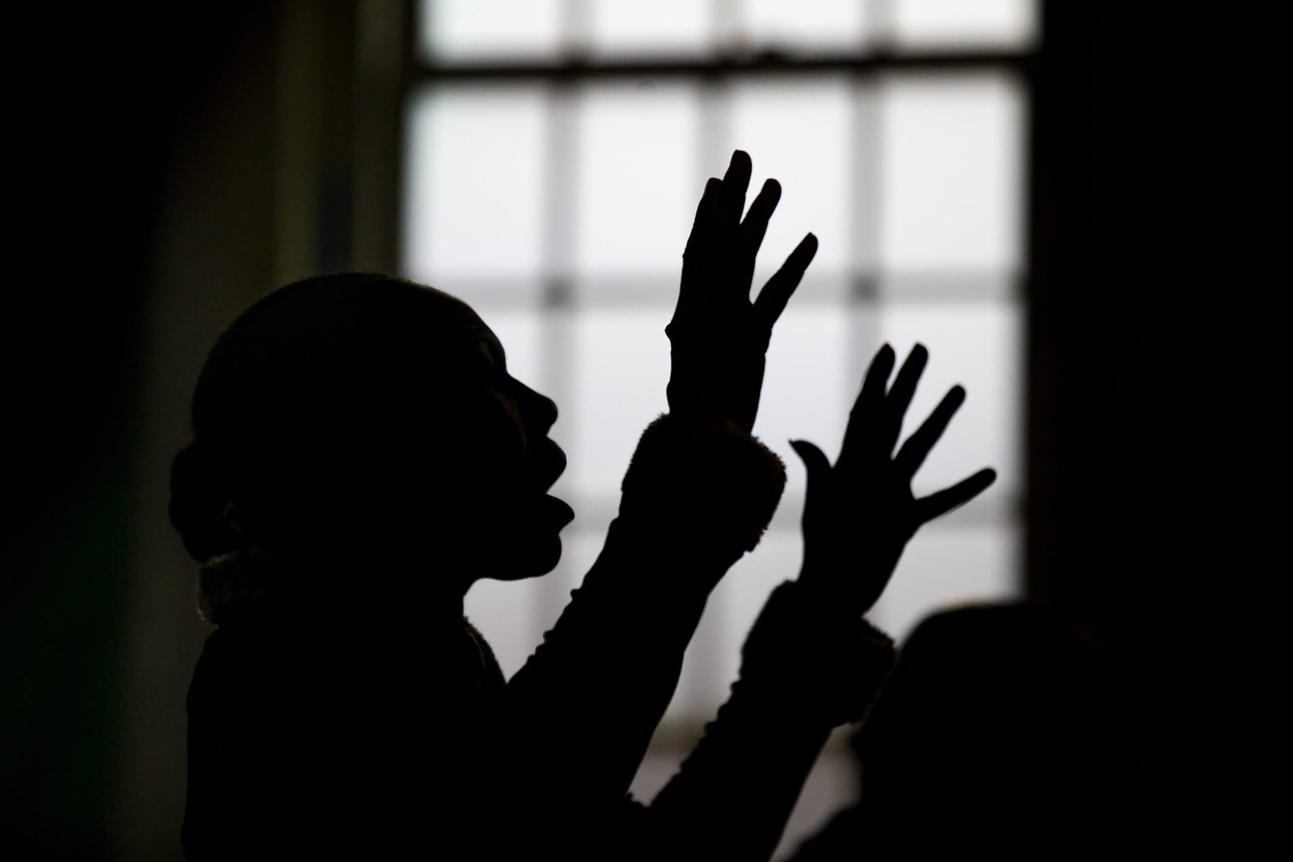 A parishioner at the Universal Missionary Church sings during a recent service. (Jesse Costa/WBUR)
