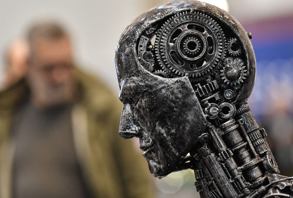 A metal head made of motor parts symbolizes artificial intelligence, or AI, at the Essen Motor Show for tuning and motorsports in Essen, Germany. (Martin Meissner/AP)
