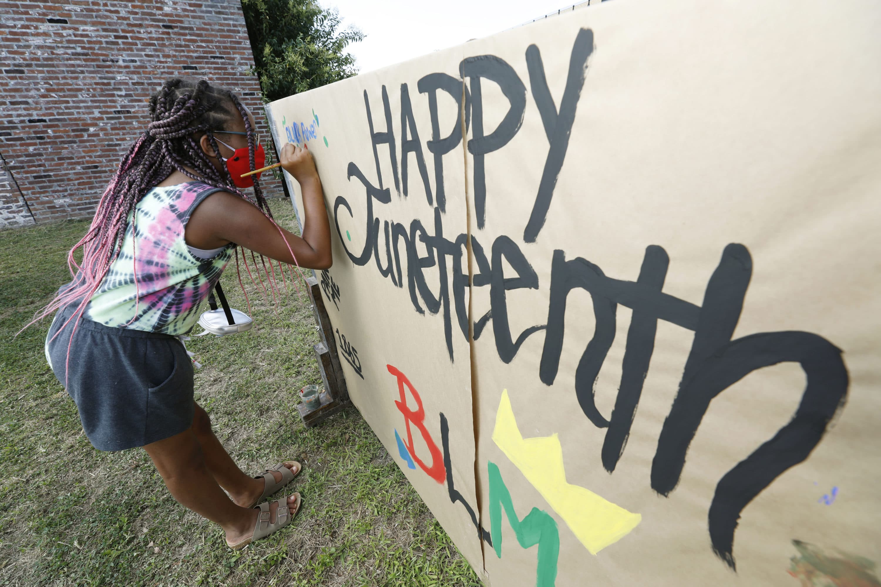 Amya Watson, 11, prints "Black Power," on a poster celebrating Juneteenth during the "Black Joy as Resistance! Juneteenth Celebration" in the historic Farish Street business district in downtown Jackson, Miss., Friday, June 19, 2020. (Rogelio V. Solis/AP)