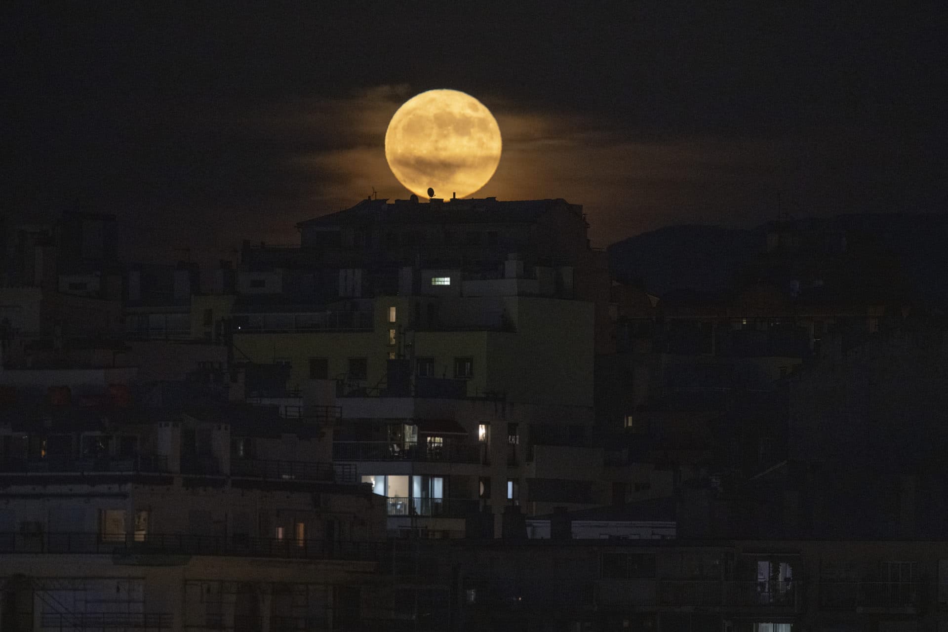 The full moon rises over Marseille, southern France, Tuesday, June 14, 2022. (Daniel Cole/AP)