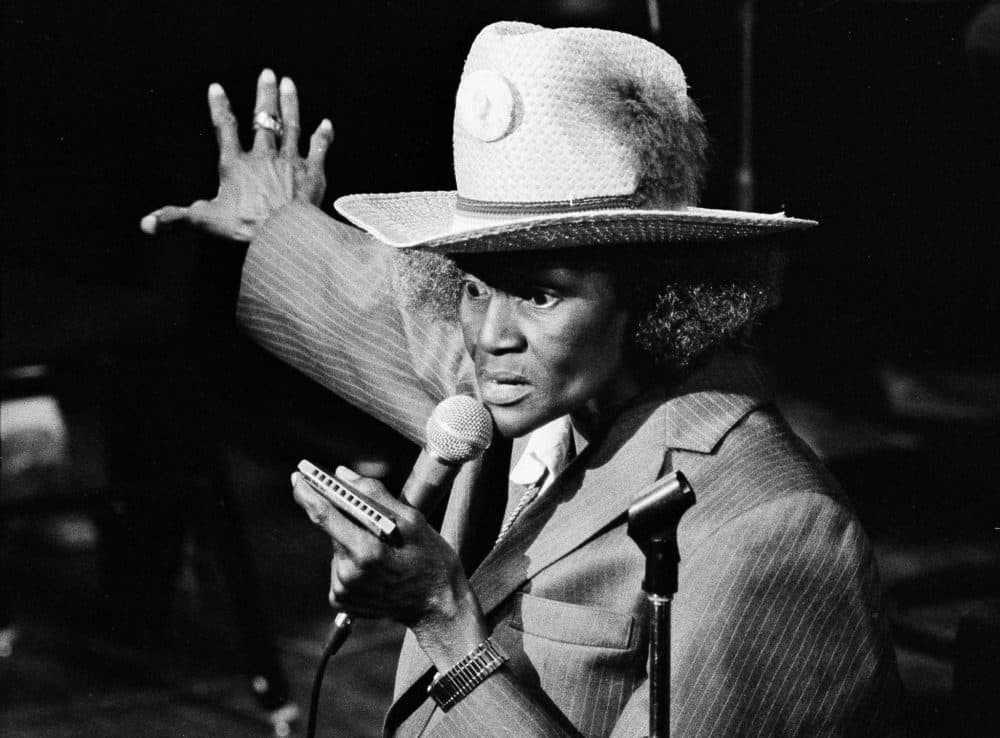 Dressed in a padded man's suit and straw Stetson, Big Mama Thornton grabs her harmonica as she lets loose at the Newport Jazz Festival at New York's Avery Fisher Hall, July 2, 1980 in a program devoted to the women who sing the blues. (Carlos Rene Perez/AP)