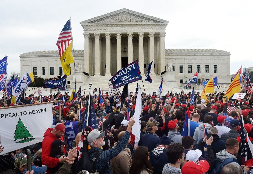 Supporters of President Donald Trump participate in the Million MAGA March to protest the outcome of the 2020 presidential election, in front of the US Supreme Court on December 12, 2020 in Washington, DC. (Photo by Olivier Douliery / AFP via Getty Images)