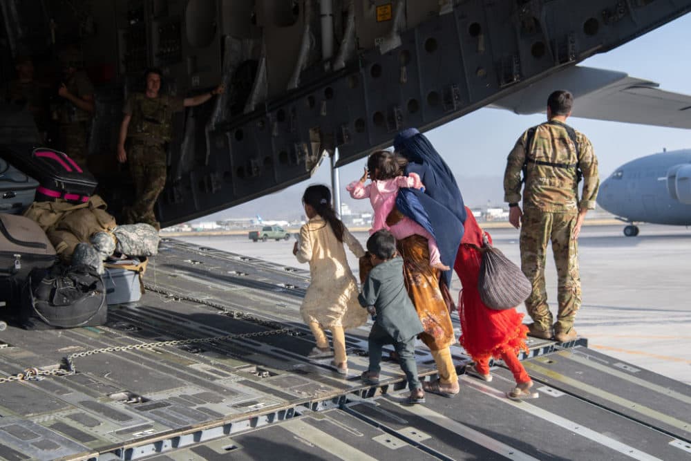 In this handout provided by U.S. Central Command Public Affairs, U.S. Air Force loadmasters and pilots assigned to the 816th Expeditionary Airlift Squadron, load passengers aboard a U.S. Air Force C-17 Globemaster III in support of the Afghanistan evacuation at Hamid Karzai International Airport (HKIA) on August 24, 2021 in Kabul, Afghanistan. (Master Sgt. Donald R. Allen/U.S. Air Forces Europe-Africa via Getty Images)