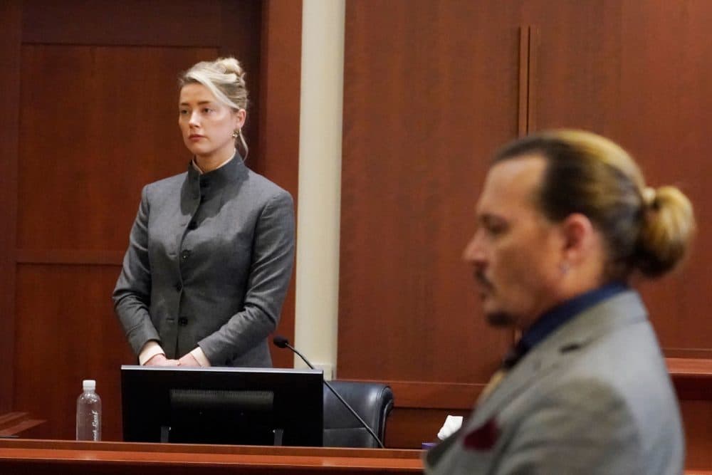 Amber Heard and Johnny Depp watch as the jury leaves the courtroom at the end of the day at the Fairfax County Circuit Courthouse in Fairfax, Virginia, May 16, 2022.(Steve Helber/POOL/AFP via Getty Images)