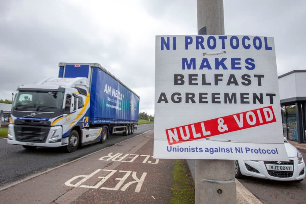 A lorry passes an anti 'Northern Ireland Protocol' sign north of Belfast in Northern Ireland on May 17, 2022. (Paul Faith/AFP via Getty Images)